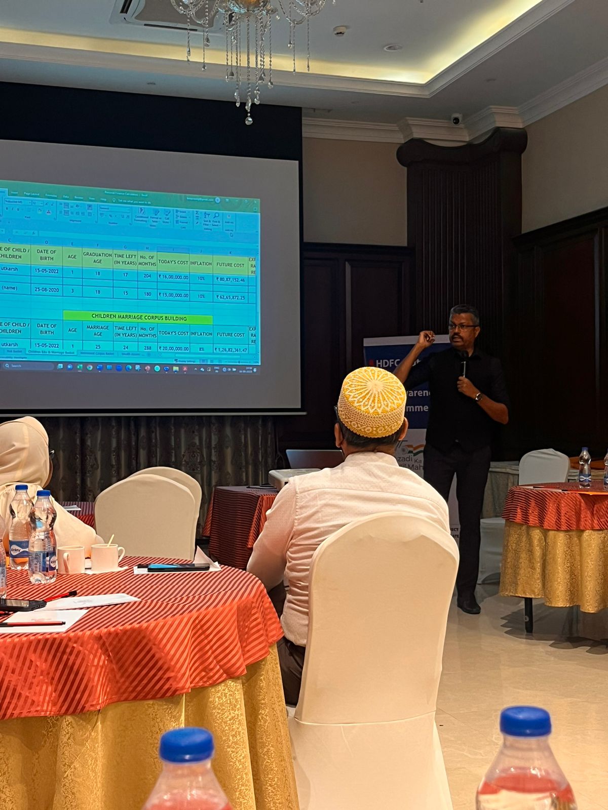 Speaker presenting financial planning with projector