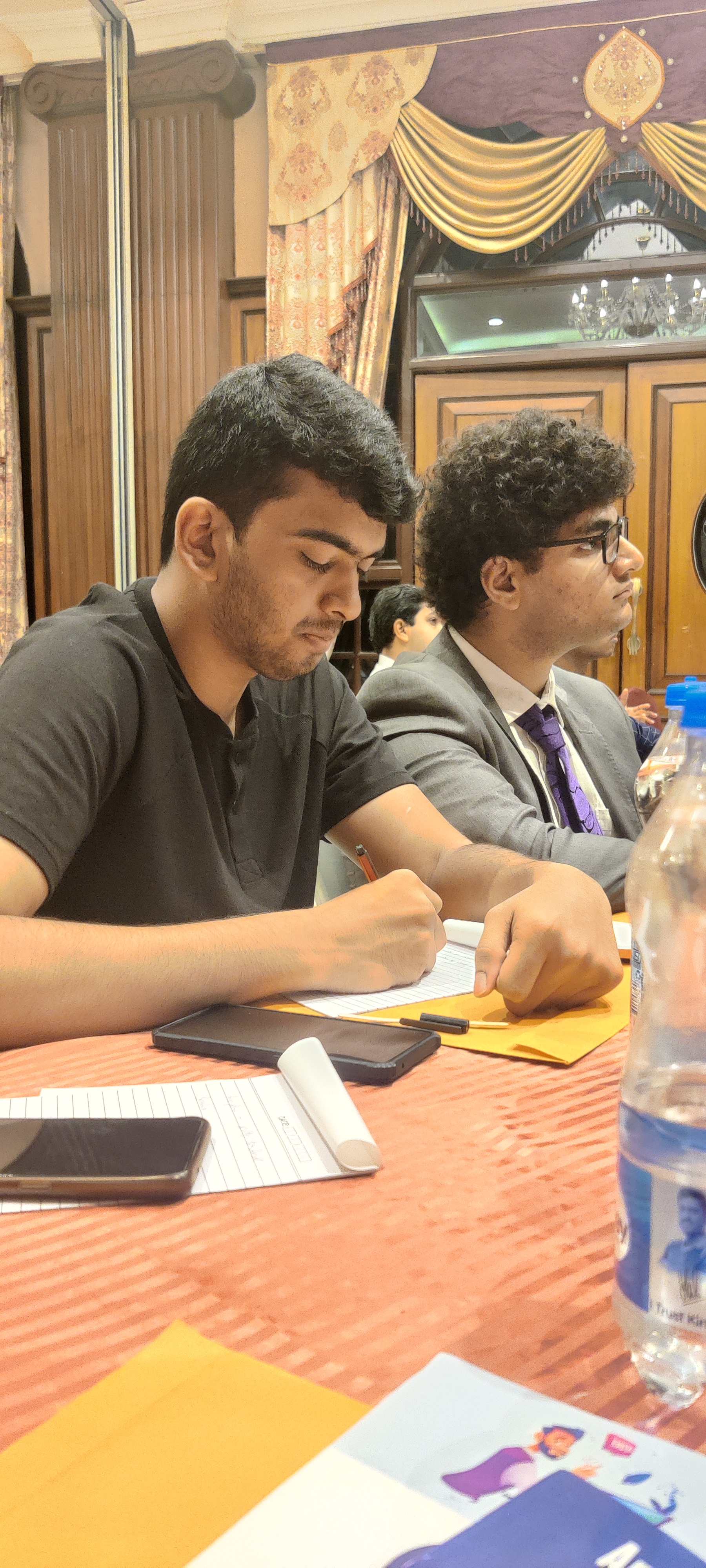 Attendees taking notes during presentation